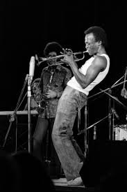  Miles Davis reaching for his